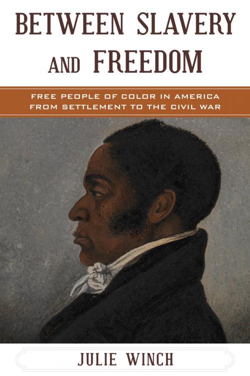 Cover of the book Between Slavery and Freedom by Julie Winch, Jacqueline M. Moore, Nina Mjagkij, Rowman & Littlefield Publishers