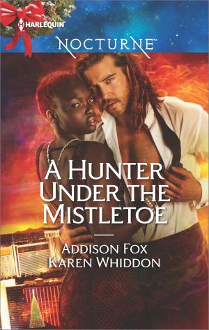 Cover of the book A Hunter Under the Mistletoe by Carole Mortimer
