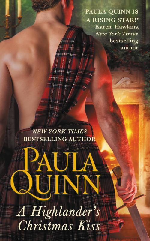Cover of the book A Highlander's Christmas Kiss by Paula Quinn, Grand Central Publishing